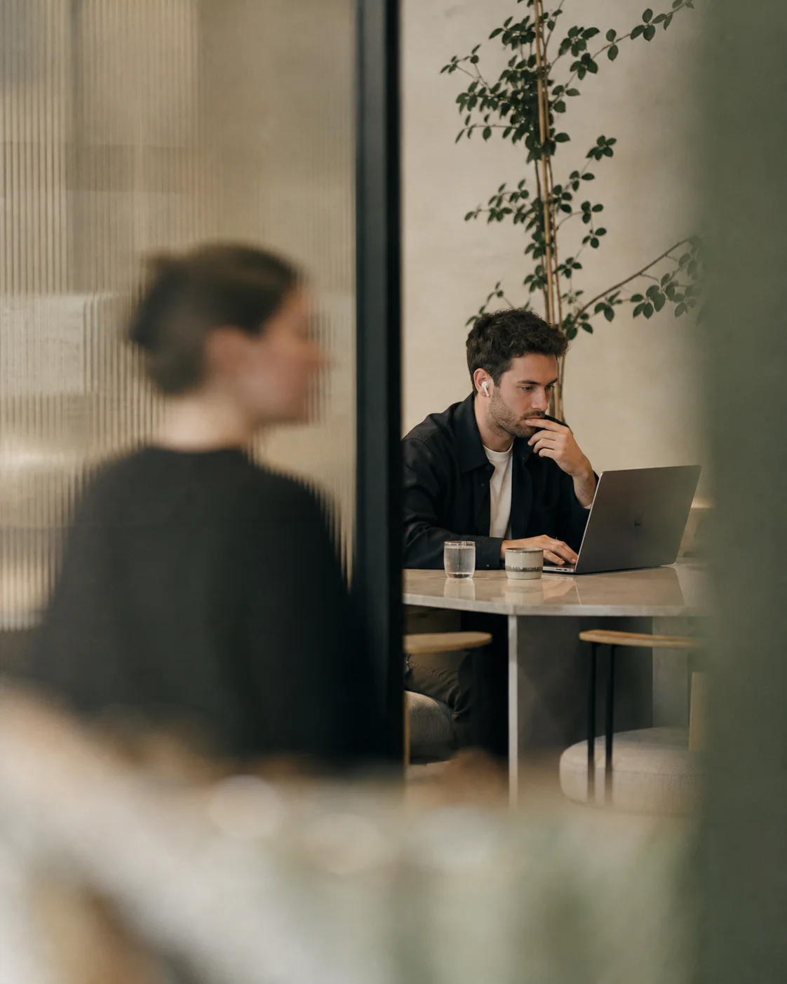 A professional working through client communication from a cafe